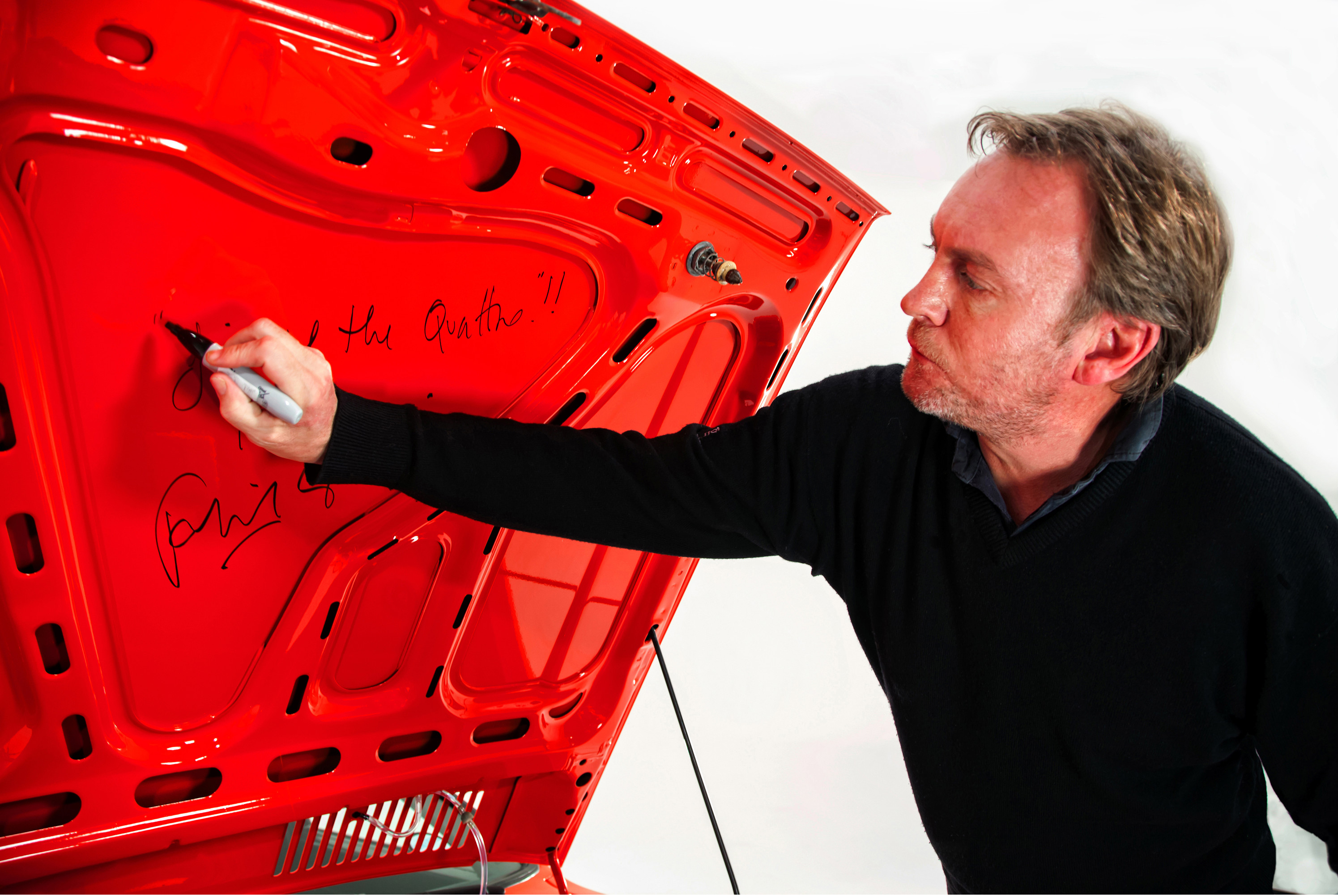 Phil Glenister signs Audi Quattro bonnet