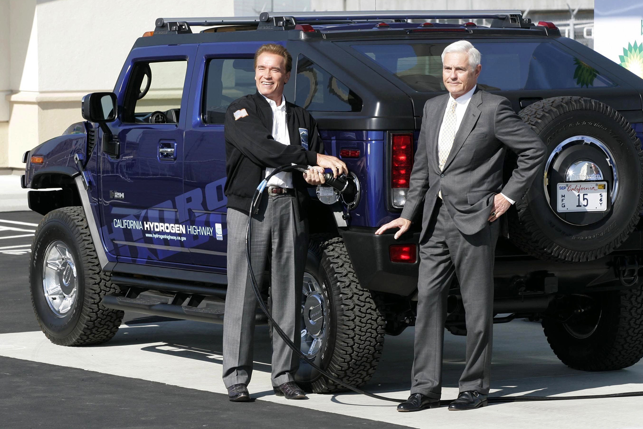 Pumping ion: Arnold Schwarzenegger, left, fills his hydrogen Hummer