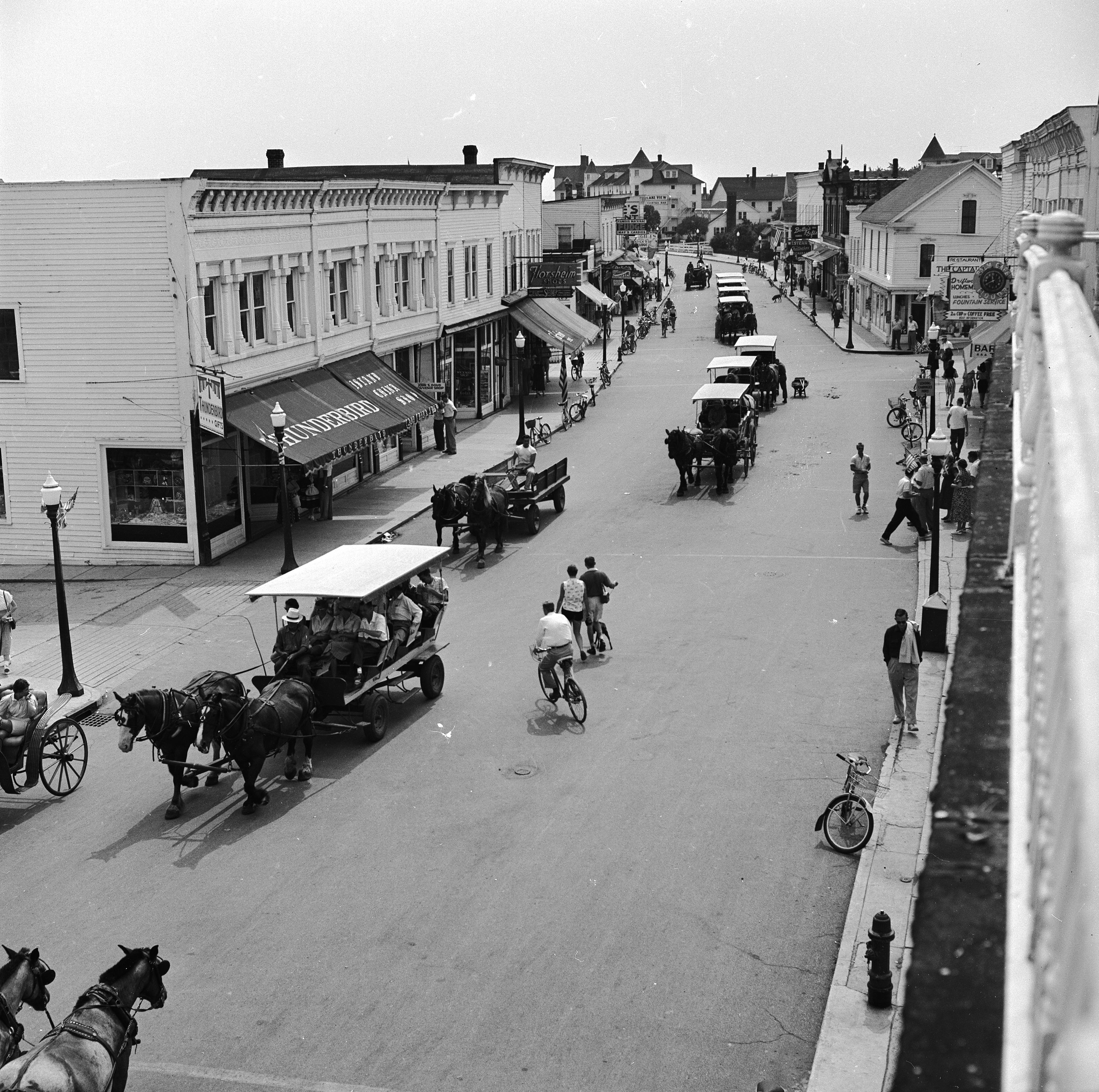 circa 1955: Horse drawn carts and bicyles passing along the main street of Mackinac Island, Michigan where the use of cars is prohibited. (Photo by Orlando /Three Lions/Getty Images)