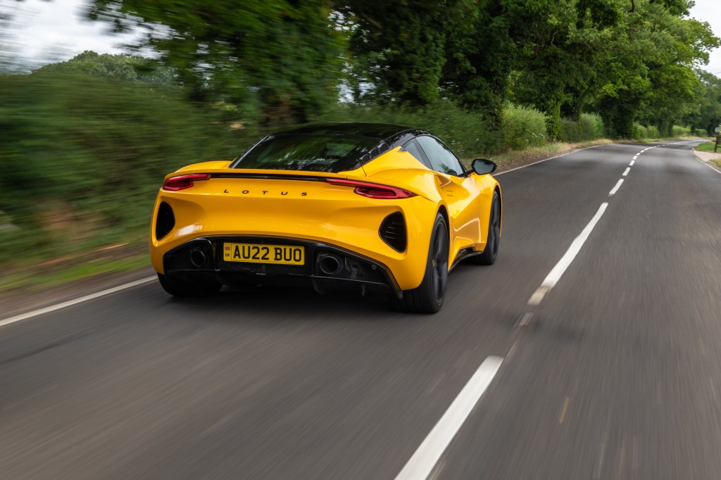 Yellow Lotus Emira on the road, rear 3/4 view