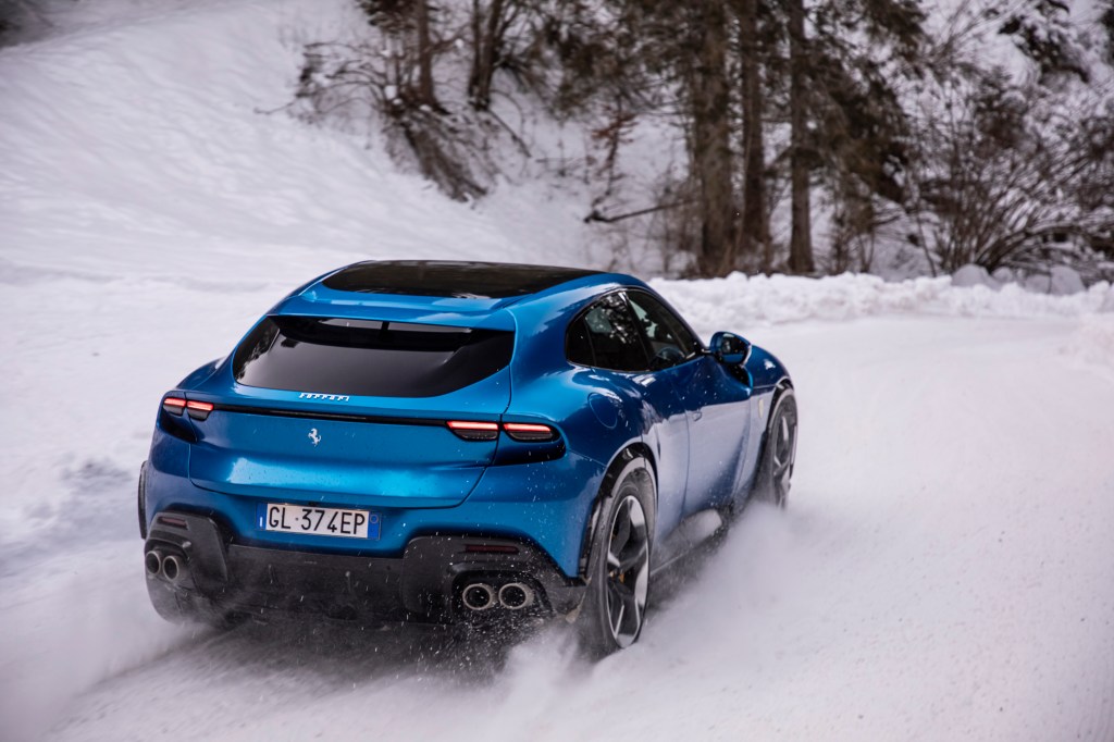 Will Dron drives the Ferrari Purosangue on snow, rear 3/4 action shot