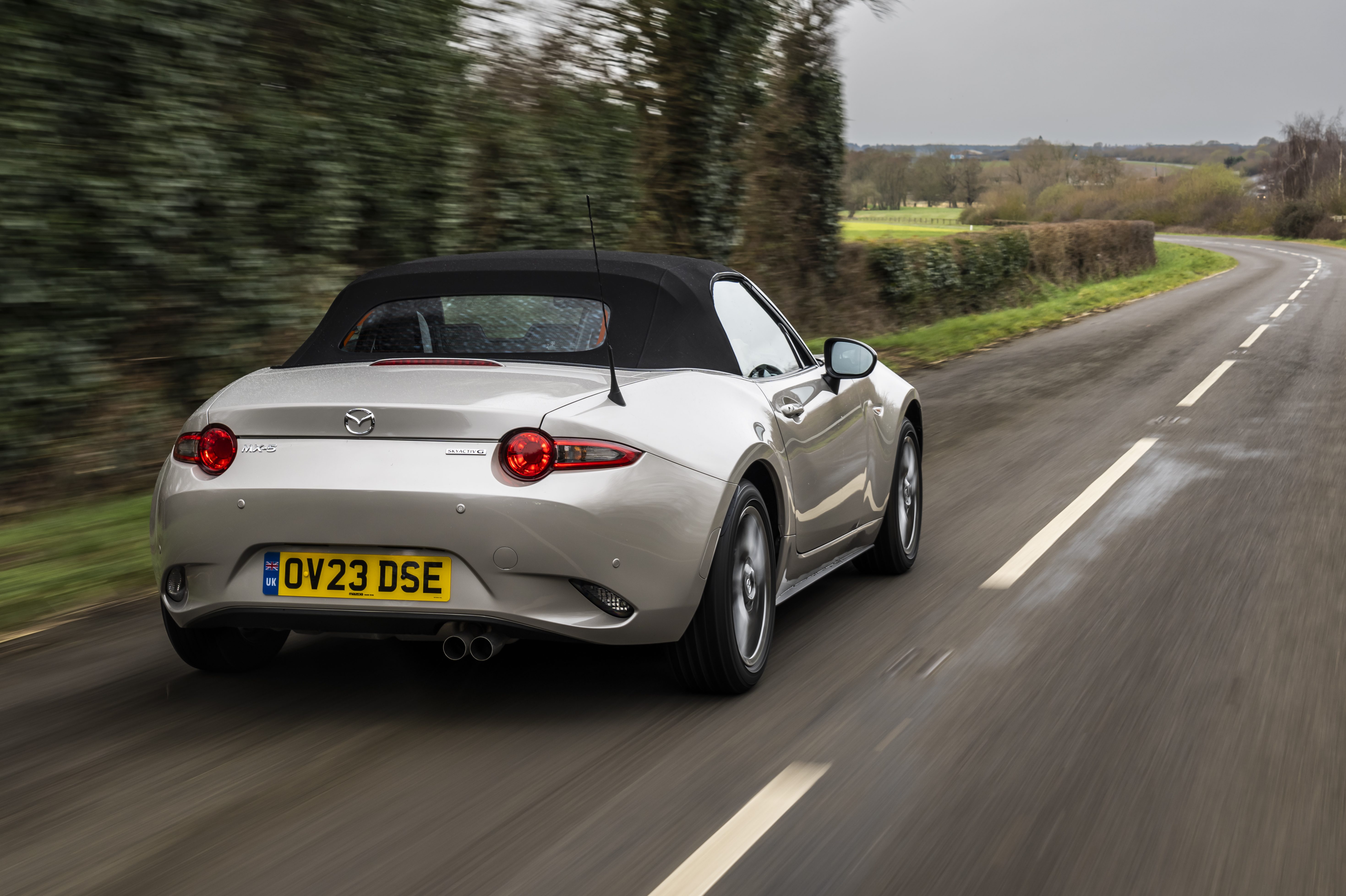 2023 Mazda MX-5 sports car rear 3/4 shot in action