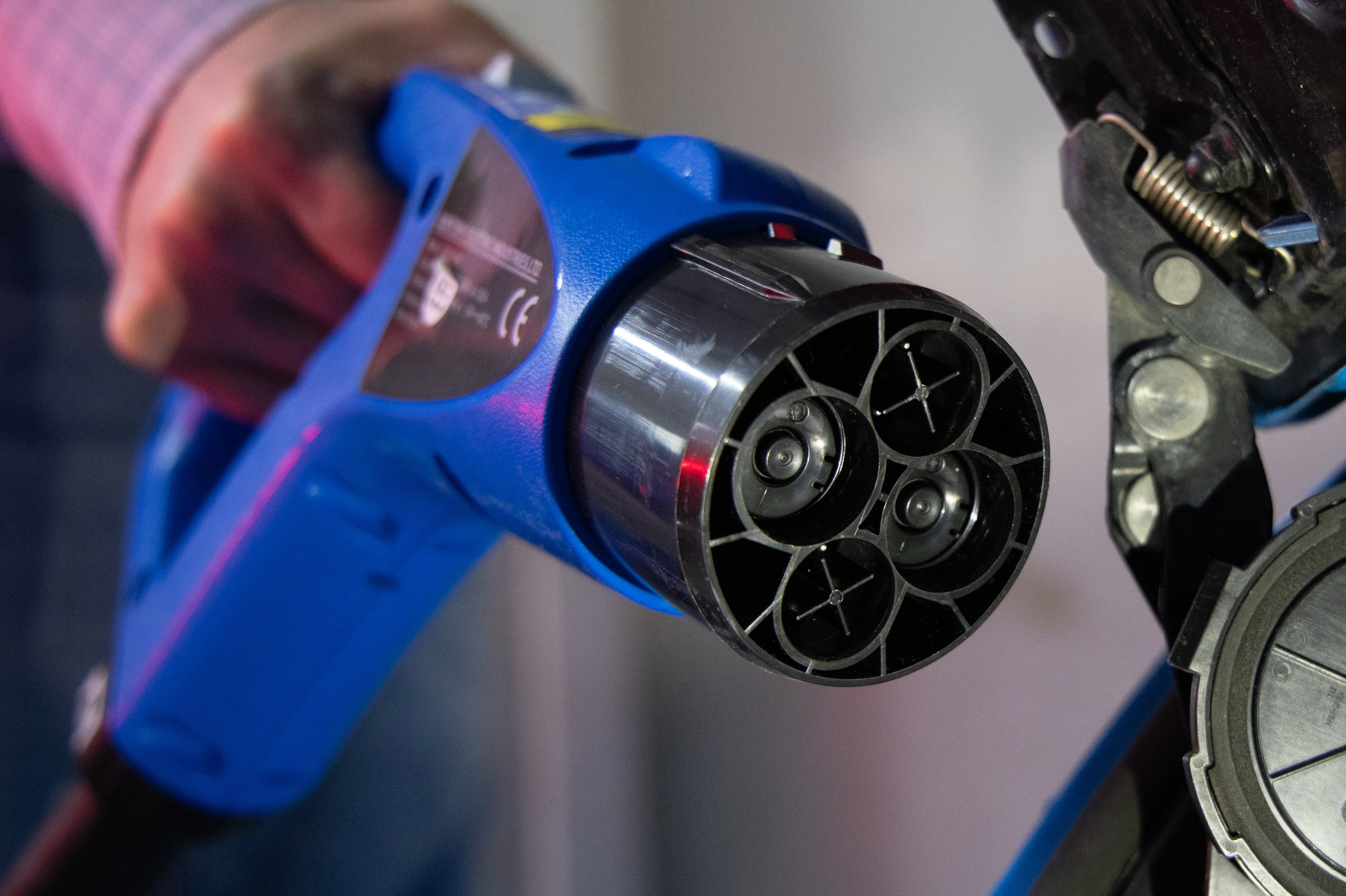 A worker connects a charging plug to a Nissan Motor Co. Leaf electric vehicle (EV) at the Parus Electro LLC production site in Moscow, Russia, on Friday, Feb. 18, 2022. Russia, one of the worlds biggest oil and gas producers, has a plan to bring more electric vehicles to its roads over the next three years and to build a market for battery-powered cars. Photographer: Andrey Rudakov/Bloomberg via Getty Images