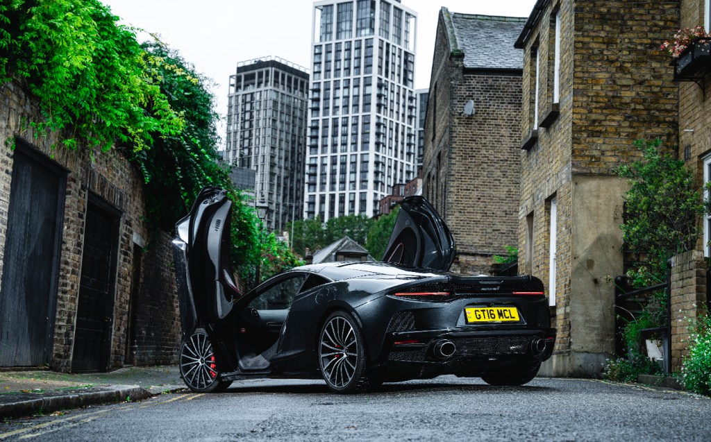 McLaren GT with dorrs open rear view in London