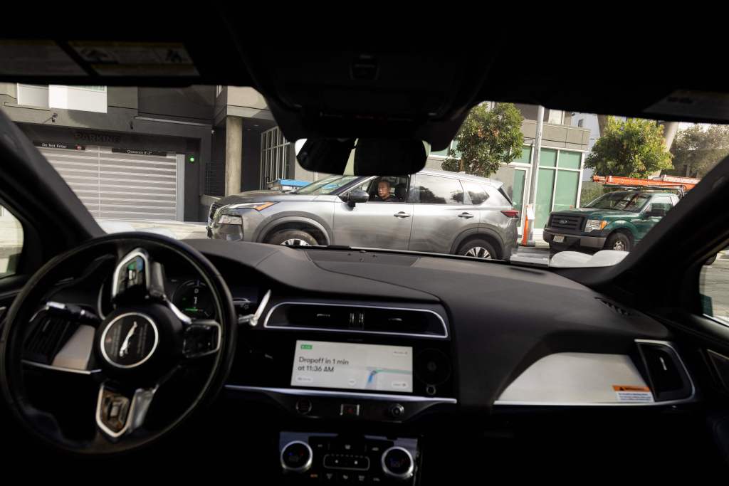 A Waymo autonomous vehicle navigating a right turn onto Brady Street in San Francisco, on November 17, 2023. (Photo by Jason Henry / AFP) (Photo by JASON HENRY/AFP via Getty Images)