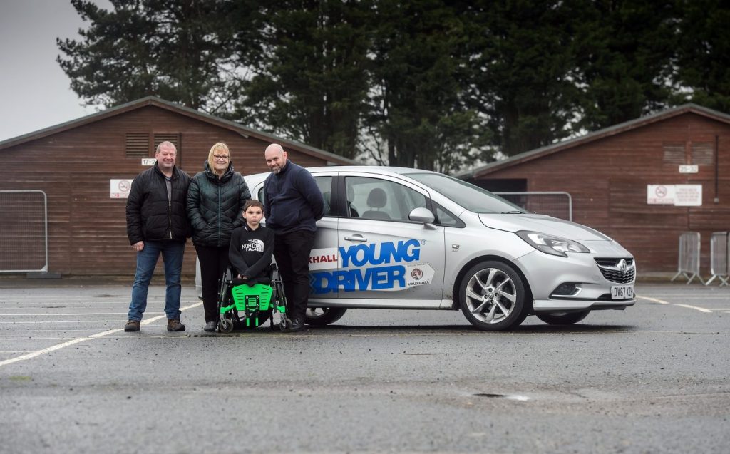 Tony Hudgell with his adoptive parents Mark and Paul and his Young Driver instructor Neil Cobbin